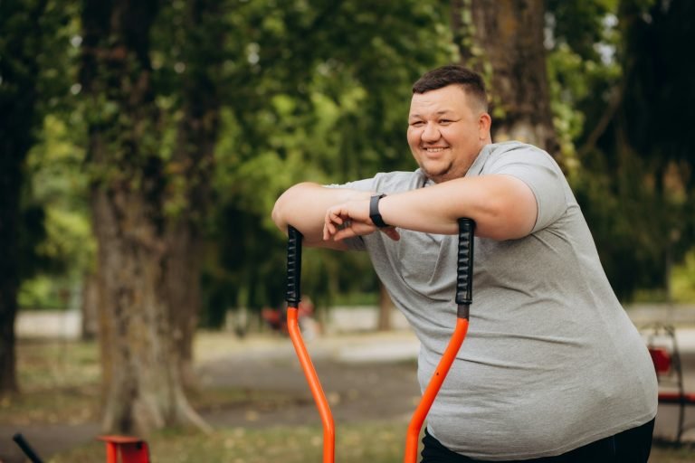 a fat man loses weight on an exercise bike