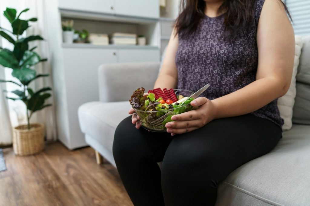 Asian Overweight woman dieting Weight loss eating fresh fresh homemade salad healthy eating concept